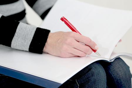 Woman makes entries in an albumの写真素材