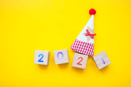Happy New year 2021 celebration. The inscription 2021 from childrens educational wooden cubes on a bright yellow backgroundの写真素材