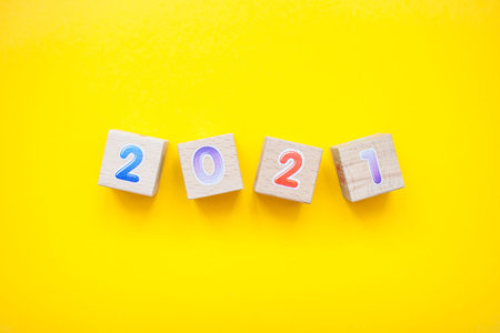 Happy New year 2021 celebration. The inscription 2021 from childrens educational wooden cubes on a...