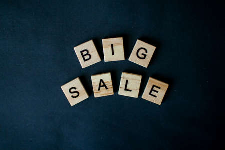 The inscription big sale from wooden blocks on a black backgroundの写真素材
