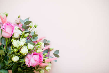 Delicate touching bouquet of white and pink flowers on a light pink background. Layout. Flat layの写真素材