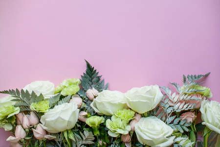 Arrangement of delicate pink spray roses and white roses and flowers on a pink background. High quality photoの写真素材