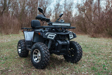 black quad bike on green grassの写真素材