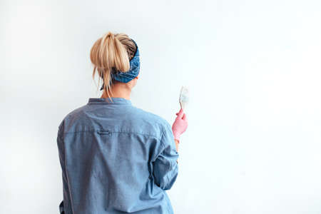 girl paint the wall with a brush.の写真素材