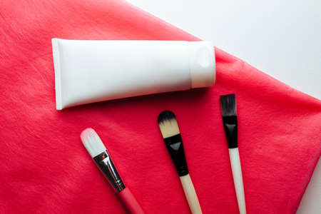 tube with cream and brushes. Concept mask for skin care of the leader. Cosmetology and spaの写真素材