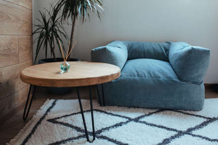 stylish air freshener stands on a wooden table in a modern interiorの写真素材