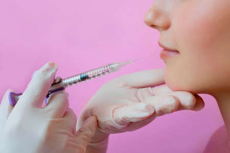 sensual female lips, procedure lip augmentation. Syringe near womans mouth, injections for increase lips shape.の写真素材