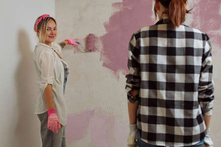 Sexy girl designer eats sushi on the construction site. painter has lunch after work.Concept interior design and room repairの写真素材