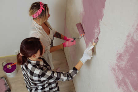 Sexy girl designer eats sushi on the construction site. painter has lunch after work.Concept interior design and room repairの写真素材