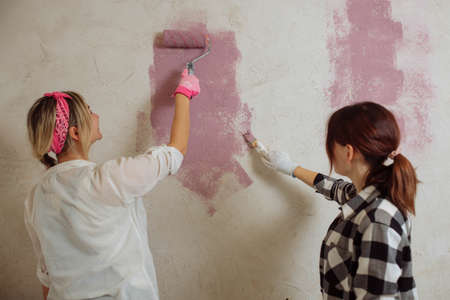 Sexy girl designer eats sushi on the construction site. painter has lunch after work. Concept interior design and room repair.の写真素材