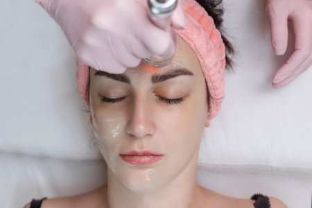 Cosmetologist making biolifting rf-lifting procedure. Rejuvenating skin, preventing aging, woman getting stimulating beauty facial treatment. hardware cosmetology in modern clinic. 4 k videoの写真素材