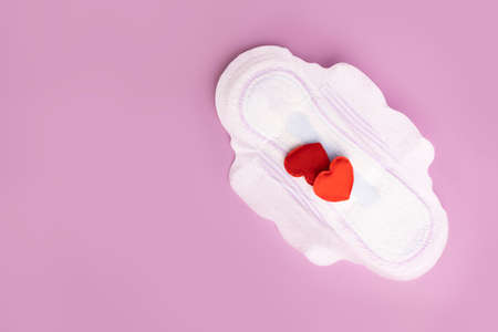 Menstruation and critical days. Gasket for menstruation on which there are two hearts in the form of blood dropsの写真素材