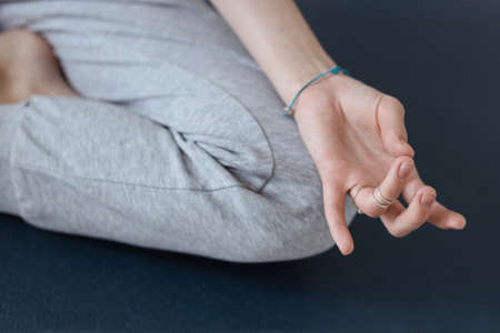 An attractive girl sits on a yoga mat. Slim body and health careの写真素材