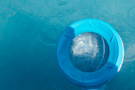 Top view of the skimmer for cleaning the pool in clear water. Close-up of the skimmer mounted on a...