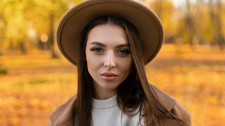 portrait of attractive stylish smiling portrait of attractive stylish smiling woman with long hair walking in the park, dressed in warm brown coat autumn trendy fashion, street style wearing hatの写真素材