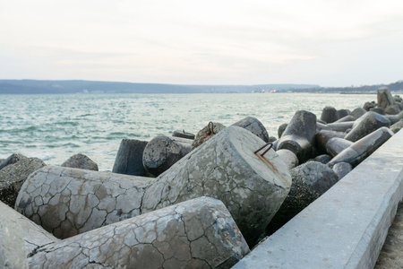 View from the Diga Sottomarina pier. Concrete breakwater with the blue sea background meeting the horizon. Seascape.の写真素材
