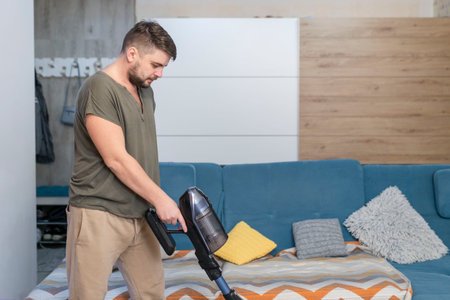 Man husband cleaning the house helping wifeの写真素材