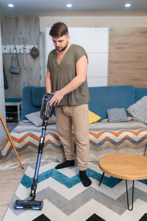 Man husband cleaning the house helping wifeの写真素材