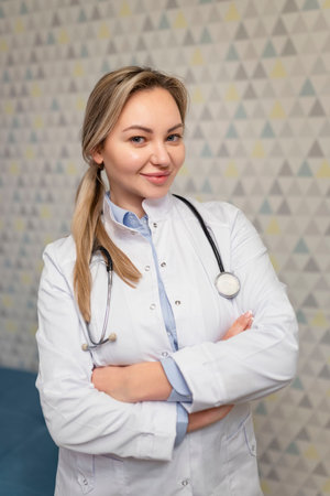 Photo of attractive family female doctor consulting patients beaming friendly smiling, white lab coat and stethoscopeの写真素材
