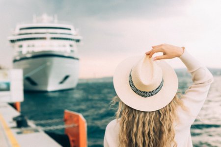 Woman tourist standing in front of big cruise liner, travel femaleの写真素材