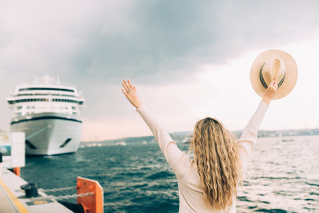 Woman tourist standing in front of big cruise liner, travel femaleの写真素材
