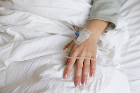 Drop of saline solution drip into patients arm in the hospital.の写真素材