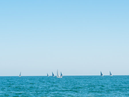 Sailing boat yacht or sailboat group regatta race on sea or ocean water.の写真素材