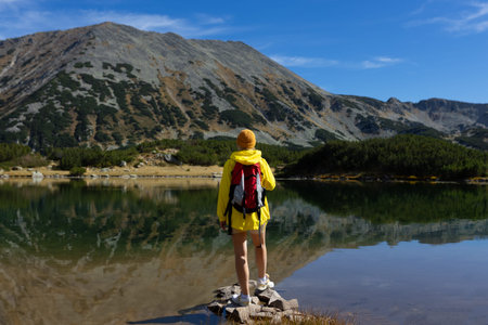 Woman tourist enjoying lake view alone outdoors Travel adventure in active holiday healthy lifestyle...