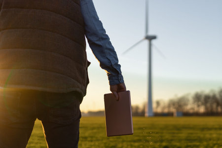 Businessman checking on wind turbine energy production