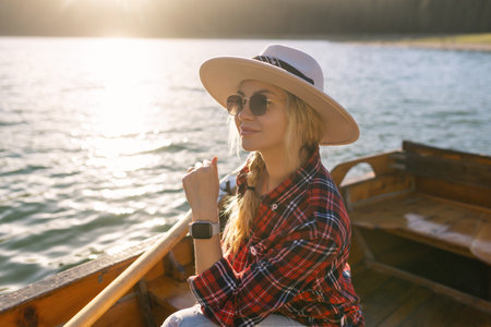 Portrait of a young woman rowing a boat on a spring day in Durmitor National Park in Montenegro.の写真素材