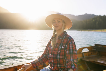 Portrait of a young woman rowing a boat on a spring day in Durmitor National Park in Montenegroの写真素材