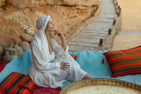 Portrait of a beautiful woman in Arabic clothing in Egypt during sunset.の写真素材