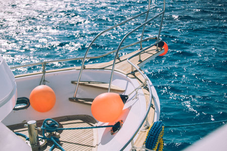Coral yacht fender against dark sea. Boat trip and vacation conceptの写真素材