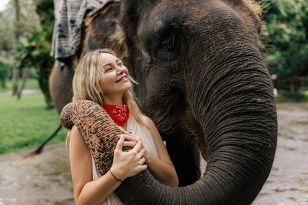 beautiful girl with smiling elephant, elephant village, baliの写真素材