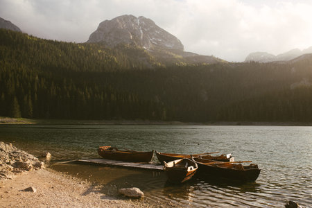 View of the Black Lake or Crno jezero , northern Montenegro. Tourist boats near wooden pier on Black...