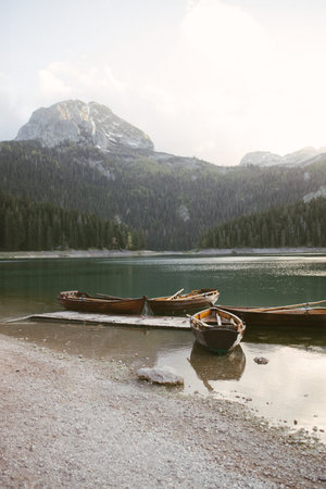 View of the Black Lake or Crno jezero , northern Montenegro. Tourist boats near wooden pier on Black lake in Durmitor national park near Zabljak, Europeの写真素材