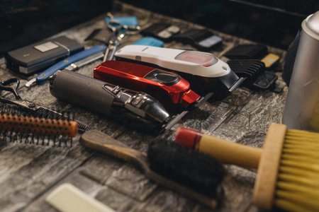 Barber workstation with professional grooming tools and electric clippers. Close up of hairstyling...