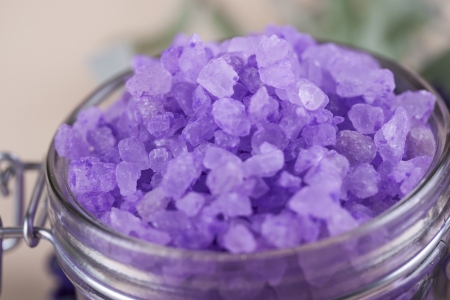 Aromatherapy and relaxation - colorful lavender bath salt in a glassの写真素材