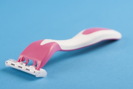 Making her legs pretty and smooth - female pink shaving razorの写真素材
