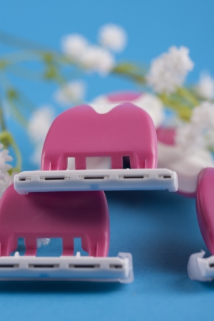 Making her legs pretty and smooth - female pink shaving razorの写真素材