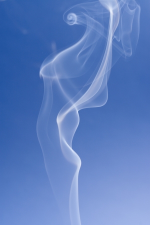 An abstract photo close up - solid blue background with a smokes swirlsの写真素材