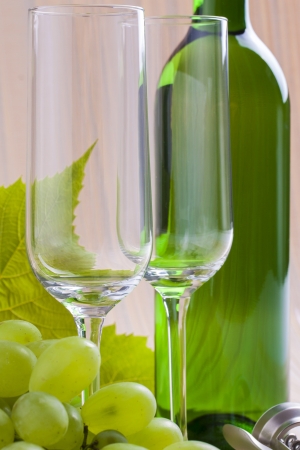 White wine bottle presented with wine glass on a orange backgroundの写真素材