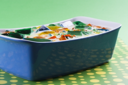 Colorful fruit jelly in a blue dish - idea for light dessert during a hot summerの写真素材