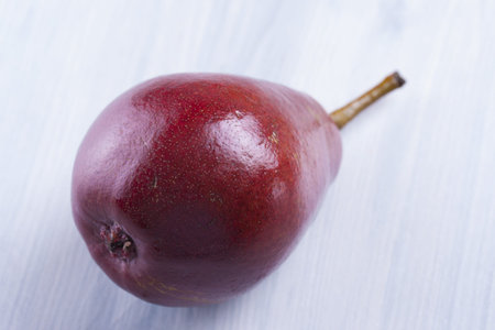 Close up photo of edible fruits - a pears  on a solid  bright blue wooden tableの写真素材