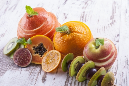 Composition of vegetarian healthy food - sliced fruits on a wooden background.の写真素材