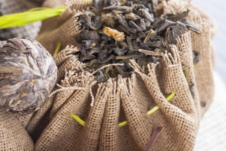 Food ingredients - a green tea leaves in a cotton brown bag.の写真素材