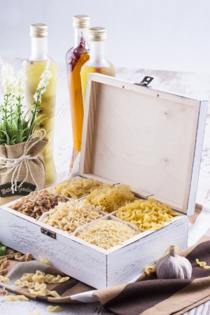 Close up photo of a noodles in a white box on a brown dish clothe and bright background.の写真素材