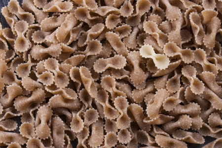 Raw food composition - yellow and brown tripolini pasta as a abstract background.の写真素材