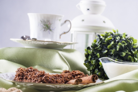 Organic cereal biscuits on a white plate placed on the green backgroundの写真素材