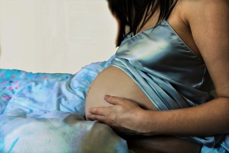 pregnant woman waiting for her childの写真素材